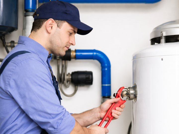 Plumber repairing residential water heater in Rockville Centre NY