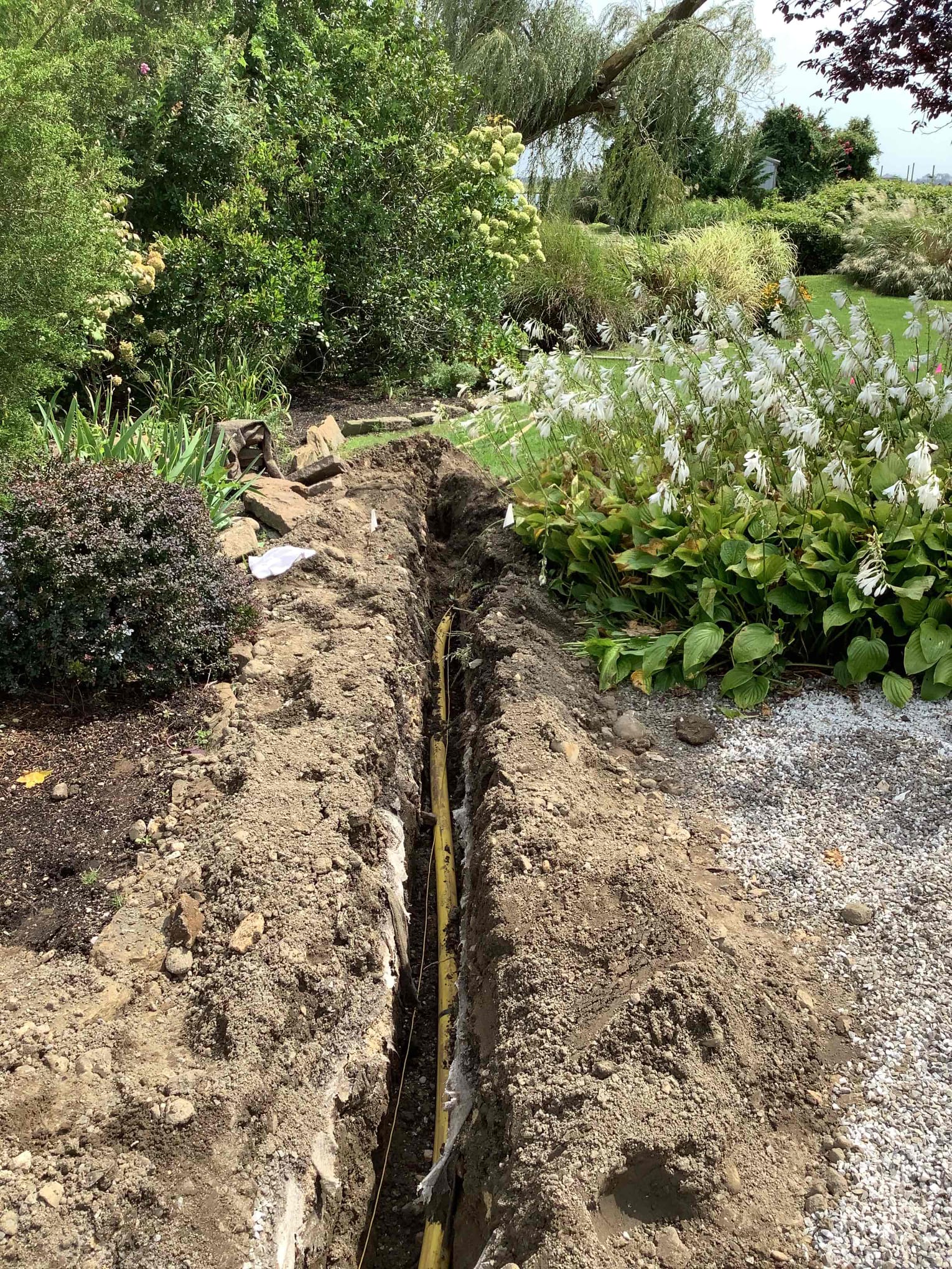 Gas line to pool heater installation underground through the garden in Rockville Centre, NY