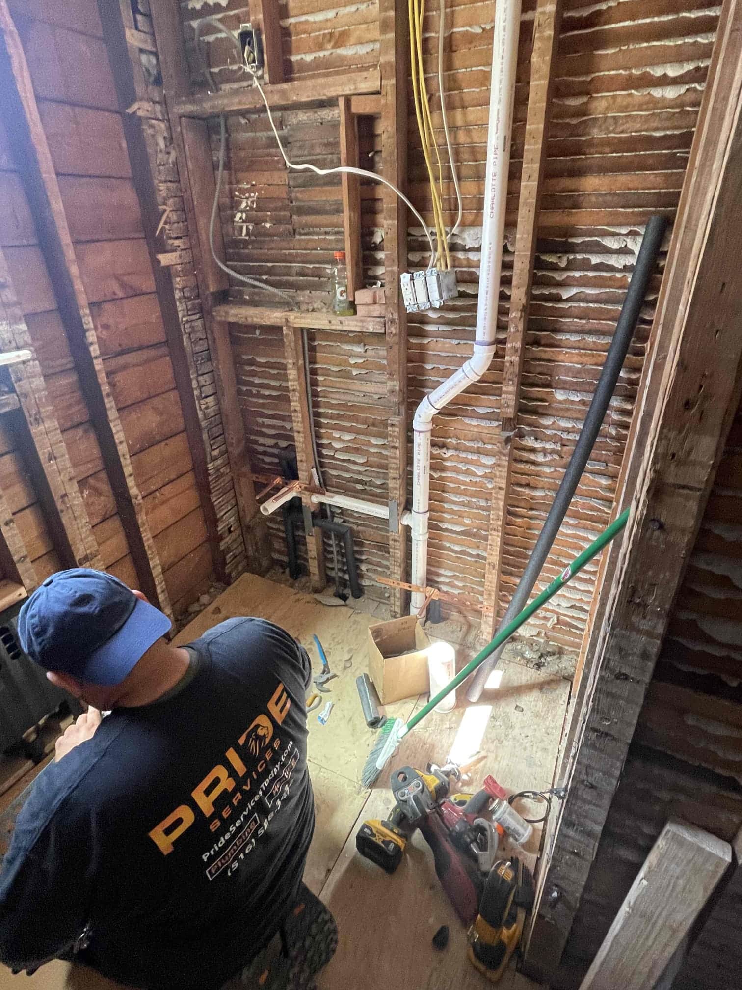 Pride Services technician working on pipping in the basement in Rockville Centre, NY